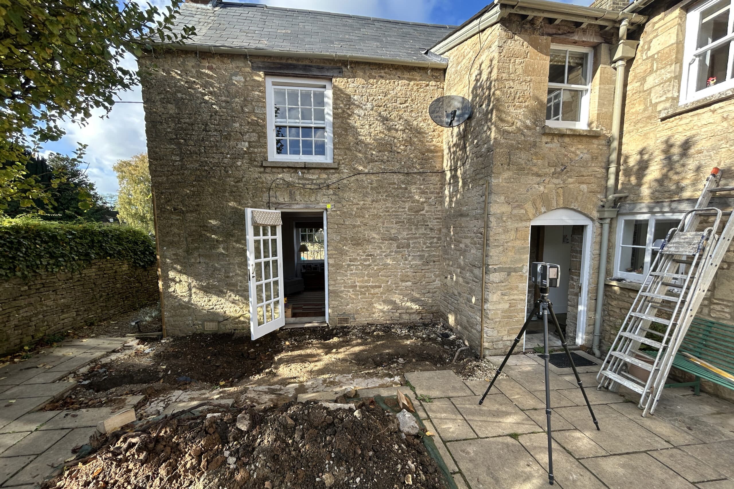 Site preparation for glass extension with 3D laser scanner capturing detailed measurements.