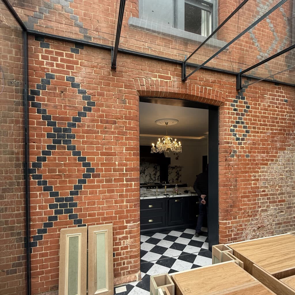 Finished interior view of the glass extension used as a light-filled breakfast room.