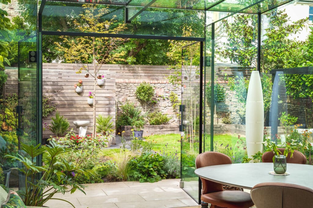 Interior of the completed modern glass kitchen extension in Bristol, filled with natural light and views of the garden through frameless glazing.