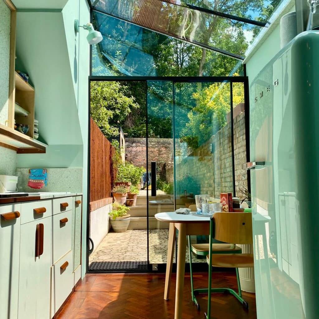 Completed glass extension interior with bright view onto the garden.